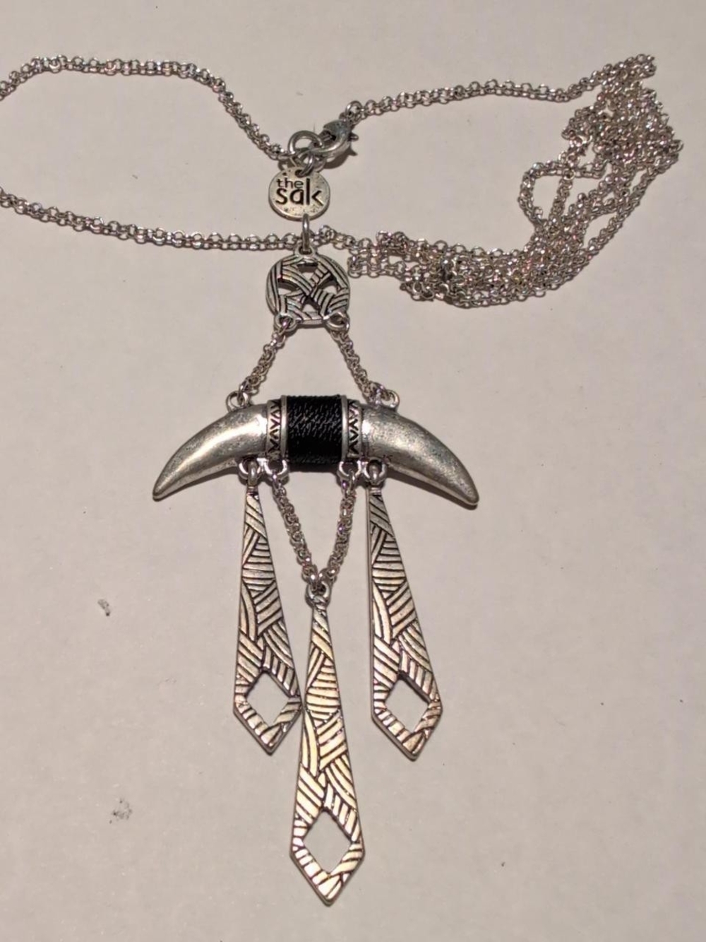 The Sak Silver and black charm necklace with claw or horn design #goth #alt